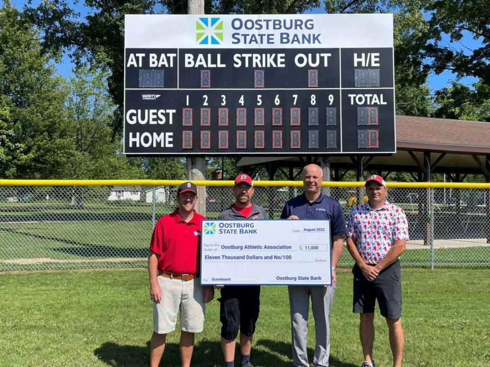 Oostburg State Bank gave $11,000 to the Oostburg Athletic Association for a new scoreboard that was erected this summer at Veterans Park baseball diamond.
