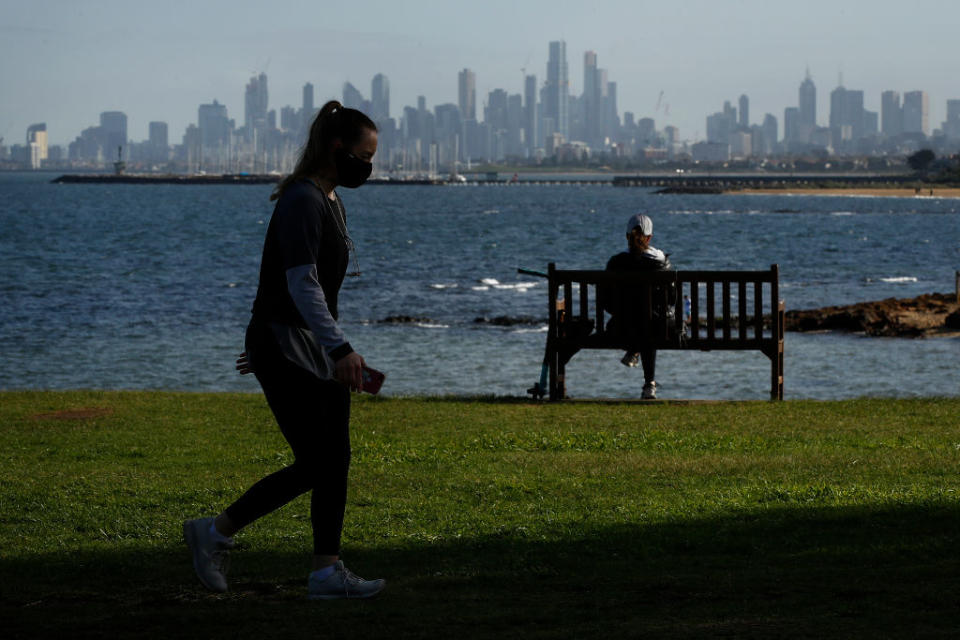 Victorian woman takes a stroll amid daylight saving debate.