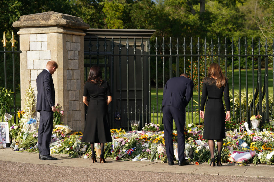 <p>From left: Prince Harry, Duke of Sussex; Meghan, Duchess of Sussex; Prince William, Prince of Wales; and Catherine, Princess of Wales view floral tributes left at Windsor Castle on Sept. 10, 2022 in England. (Photo by Kirsty O'Connor - WPA Pool/Getty Images)</p> 