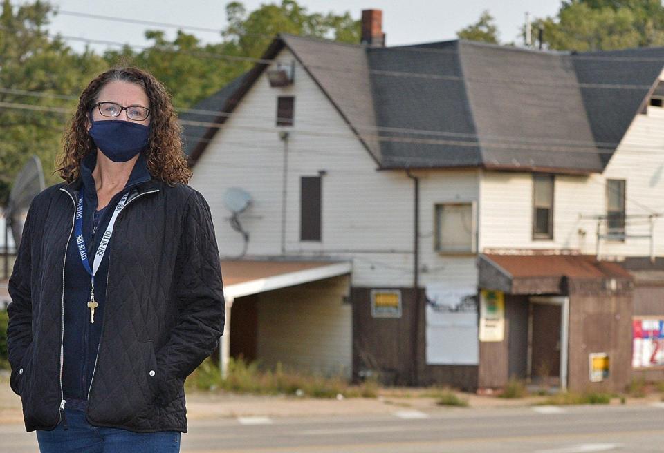 Kathy Wyrosdick, the city's former director of planning and neighborhood resources, at the northwest corner of West 12th and Cascade streets - with a blighted business in the background - in this September 2020 file photo.