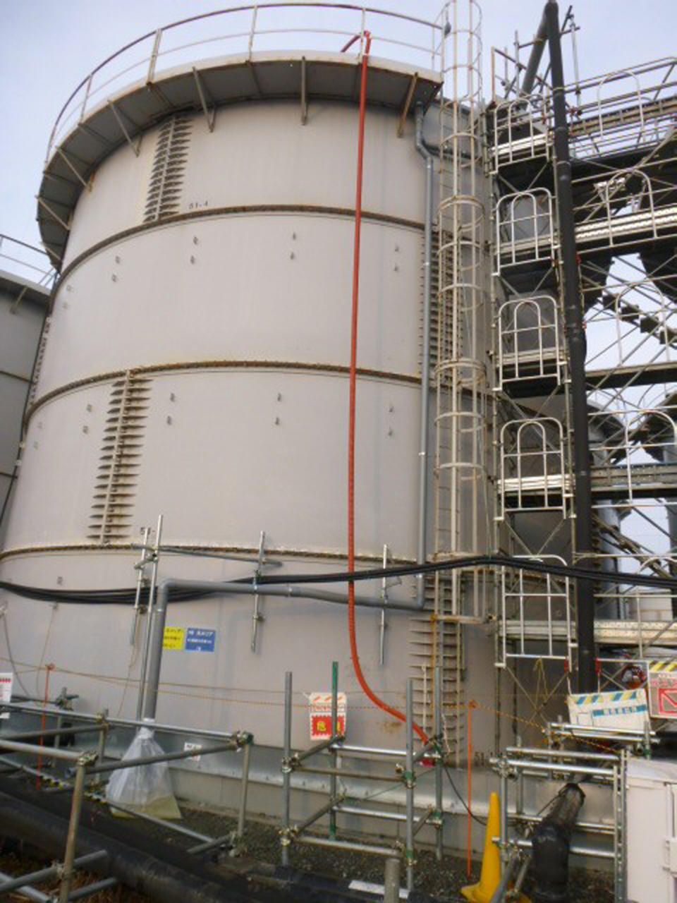 This photo released by Tokyo Electric Power Co. (TEPCO) shows a tank from which radioactive water leaked at Fukushima Dai-ichi nuclear power plant in Okuma, Fukushima Prefecture Thursday, Feb. 20, 2014. Highly radioactive water has overflowed from the storage tank, but the operator says it did not reach the Pacific Ocean. The operator, TEPCO said Thursday that the leak involved partially treated water from early in the crisis, meaning it was more toxic than previous leaks. Three reactors melted at the Fukushima Dai-ichi plant following the 2011 earthquake and tsunami, with radioactive water partially recycled and stored in more than 1,000 tanks. (AP Photo/Tokyo Electric Power Co. )