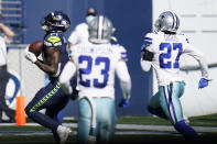 Seattle Seahawks wide receiver DK Metcalf, left, catches a pass from quarterback Russell Wilson near the end zone, but the ball was knocked loose by Dallas Cowboys cornerback Trevon Diggs during the first half of an NFL football game, Sunday, Sept. 27, 2020, in Seattle. (AP Photo/Elaine Thompson)