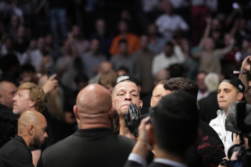 Nate Diaz, center, prepares to Tony Ferguson before a welterweight bout during the UFC 279 mixed martial arts event Saturday, Sept. 10, 2022, in Las Vegas. (AP Photo/John Locher)