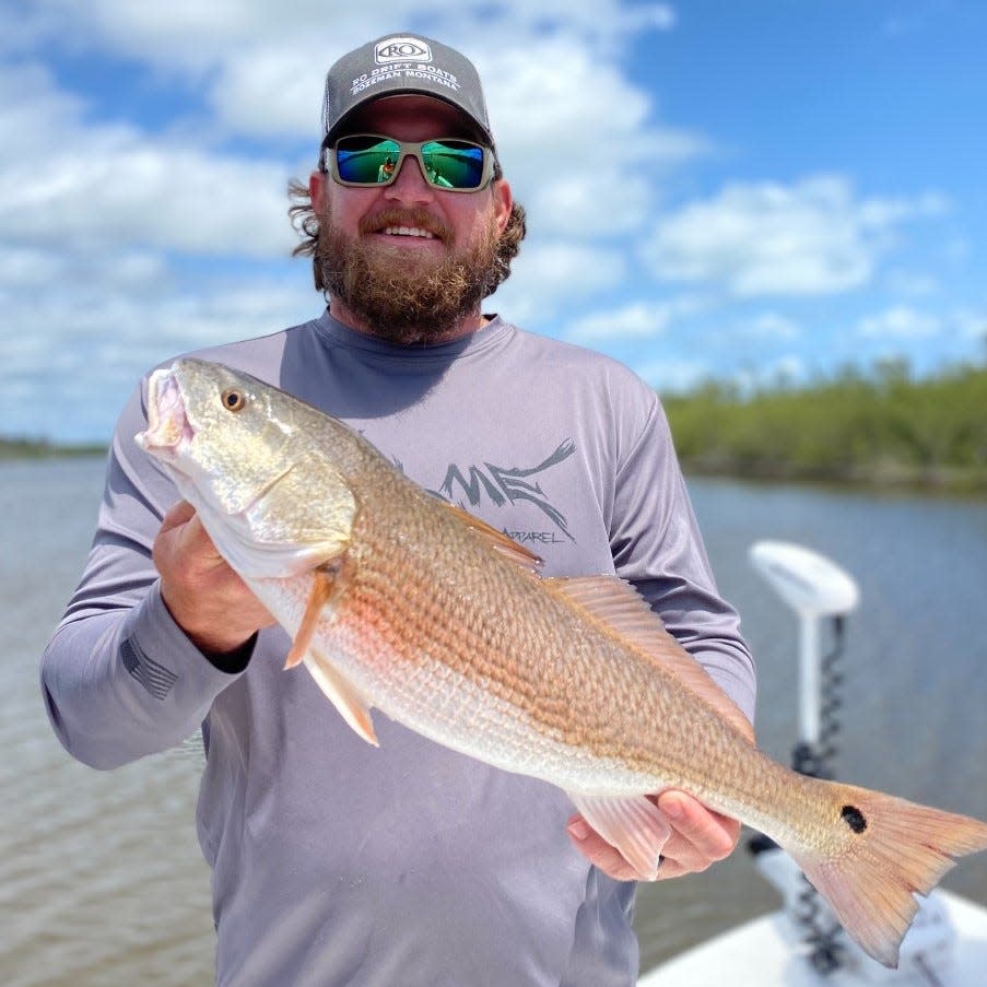 Dewey Seibert aboard Capt. Jeff Patterson's Pole Dancer charter, with a nice redfish he caught on a soft plastic lure.