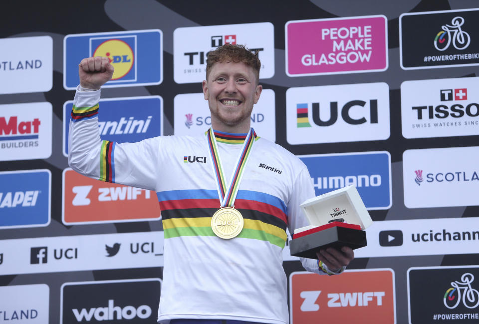 Britain's Charlie Hatton celebrates winning gold in the downhill mountain bike on day three of the 2023 UCI Cycling World Championships at the Ben Nevis Range, Fort William, Scotland, Saturday Aug. 5, 2023. (Will Matthews/PA via AP)