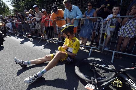 Etixx-Quick Step rider Tony Martin of Germany, race leader's yellow jersey, lies on the ground after a crash during the 191.5-km (118.9 miles) 6th stage of the 102nd Tour de France cycling race from Abbeville to Le Havre, France, July 9, 2015. REUTERS/Stephane Mantey/Pool