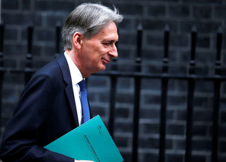 Britain's Chancellor of the Exchequer Philip Hammond leaves 11 Downing Street on his way to present his Autumn Statement in the House of Commons, in London November 23, 2016. REUTERS/Peter Nicholls/File Photo