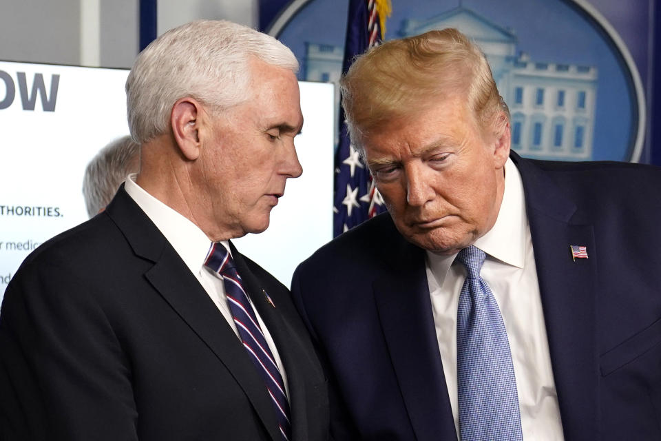 President Donald Trump listens to Vice President Mike Pence during a press briefing with the coronavirus task force, in the Brady press briefing room at the White House, Monday, March 16, 2020, in Washington. (AP Photo/Evan Vucci)