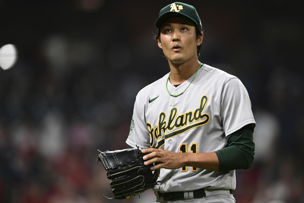 Oakland Athletics relief pitcher Shintaro Fujinami walks to the dugout after striking out Cleveland Guardians' David Fry during the eighth inning of a baseball game Tuesday, June 20, 2023, in Cleveland. (AP Photo/David Dermer)