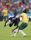Australia's Tim Cahill (R) fouls Bruno Martins Indi of the Netherlands during their 2014 World Cup Group B soccer match at the Beira Rio stadium in Porto Alegre June 18, 2014. Cahill's foul led to a yellow card, his second in the tournament, which will result him in missing his next match against Spain. REUTERS/Edgard Garrido (BRAZIL - Tags: SOCCER SPORT WORLD CUP)