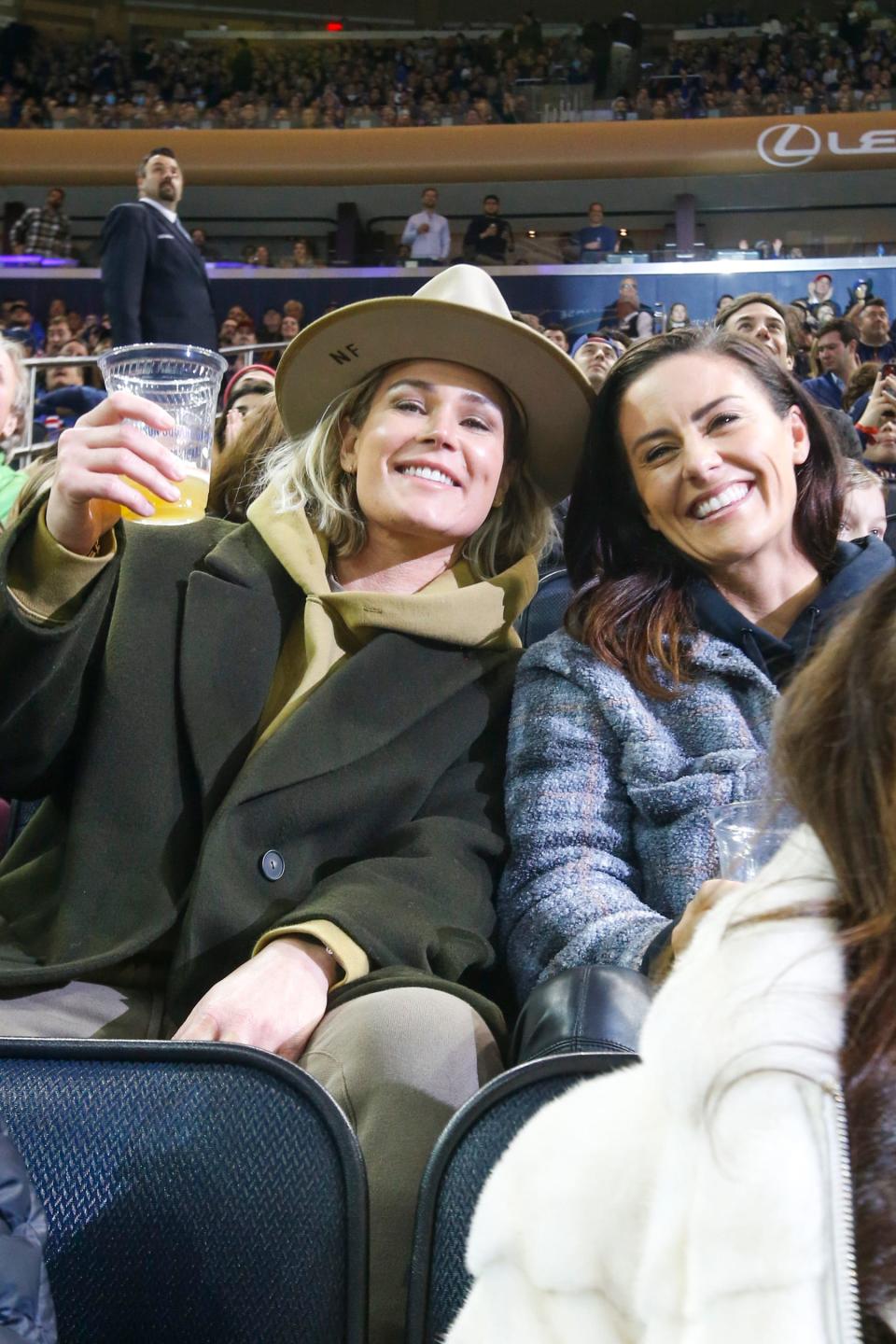 Newly-signed Gotham FC teammates and married couple Ashlyn Harris and Ali Krieger at the New York Rangers game on Wed., Dec. 8, 2021.