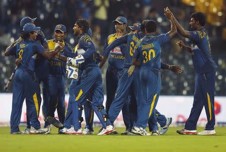 Sri Lanka cricket players celebrate after winning their first One Day International cricket match against England in Colombo November 26,2014. Sri Lanka won by 25 runs. REUTERS/Dinuka Liyanawatte