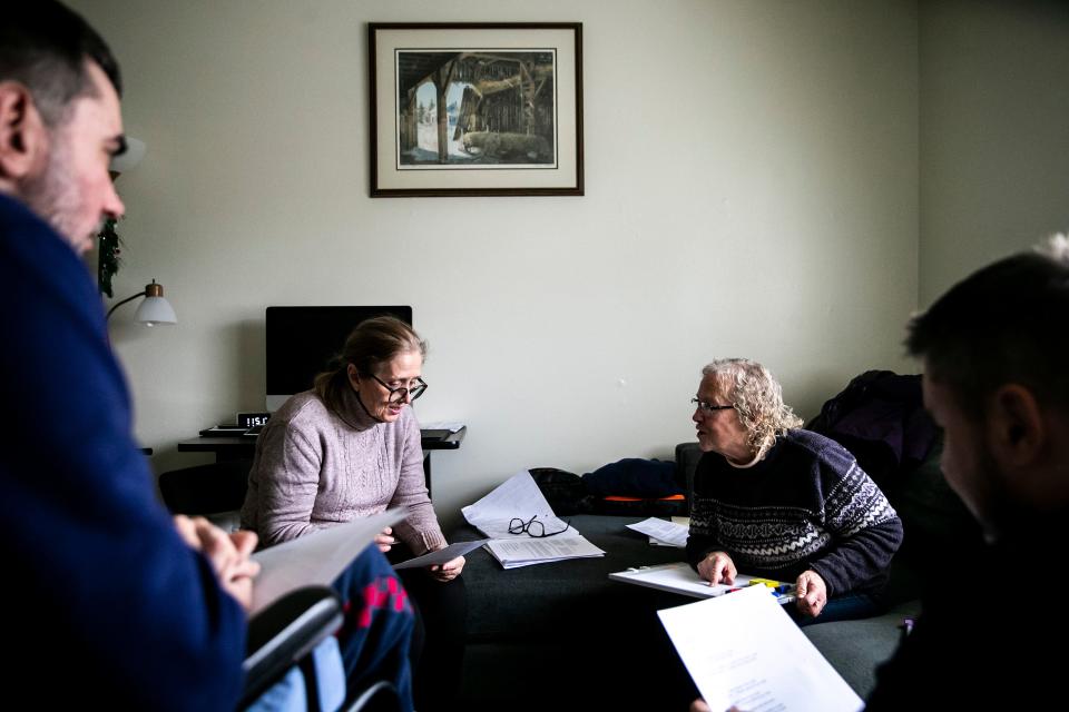 Monica Miller, second from right, helps teach English to Tetiana Kolomiiets, her sons Artem, left, and Dymtro in Iowa City.