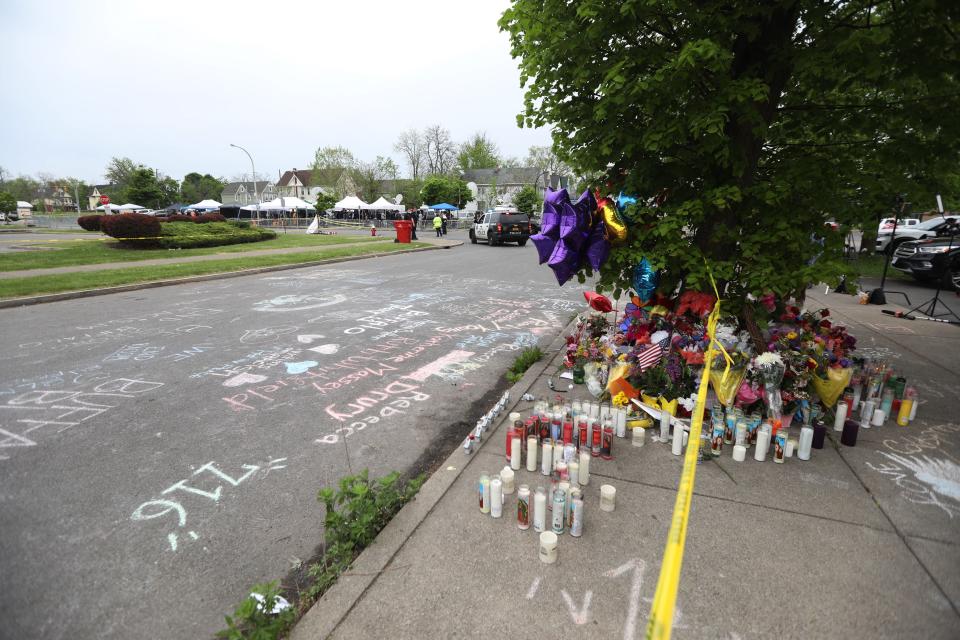 Chalk messages and memorials surround  the Tops Friendly Market store on Jefferson Ave., Buffalo, NY on May 16, 2022.  The area around Tops is still closed off including the portion of the street in front of the store and on the streets bordering the sides of the store while police and FBI continue to investigate the shooting.