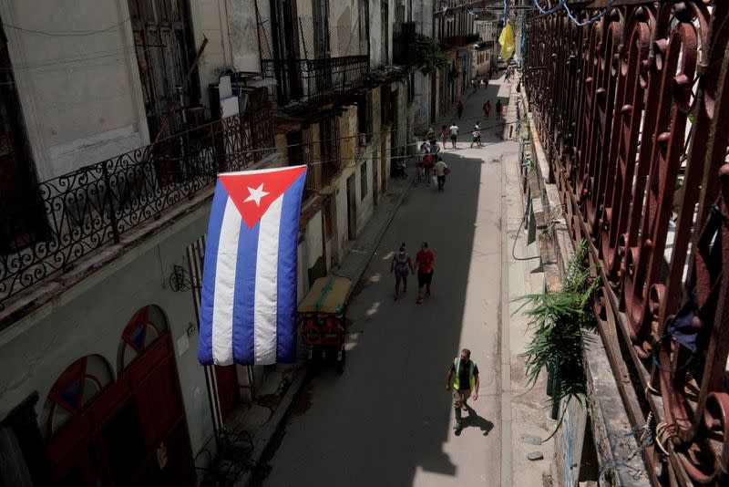 FILE PHOTO: A Cuban flag hangs over a street in Havana