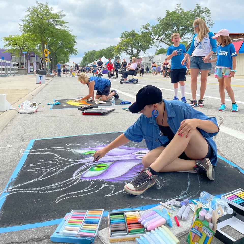 Chalk art contestants drawing on the street at Berkley Street Art Fest.