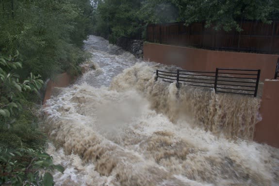 The typically placid Bear Creek in south Boulder engulfs a bike path Thursday afternoon, Sept. 12.