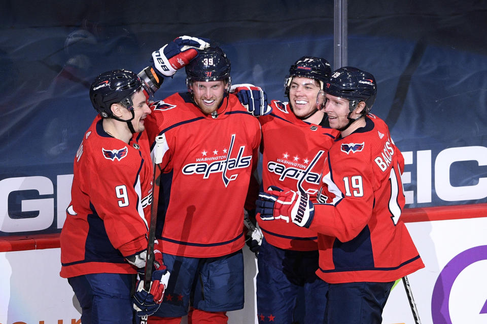 Washington Capitals right wing Anthony Mantha (39) celebrates his goal with defenseman Dmitry Orlov (9), right wing T.J. Oshie (77) and center Nicklas Backstrom (19) during the second period of an NHL hockey game against the Philadelphia Flyers, Tuesday, April 13, 2021, in Washington. (AP Photo/Nick Wass)