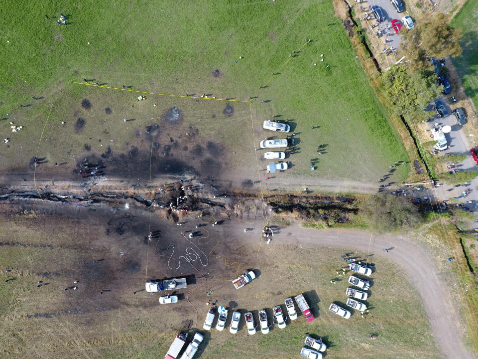 The ground is scorched where an oil pipeline exploded in Tlahuelilpan, Hidalgo state, Mexico, Saturday, Jan. 19, 2019. A massive fireball that engulfed people scooping up fuel spilling from a pipeline ruptured by thieves in central Mexico killed dozens of people and badly burned many more. (AP Photo/Alexis Triboulard)