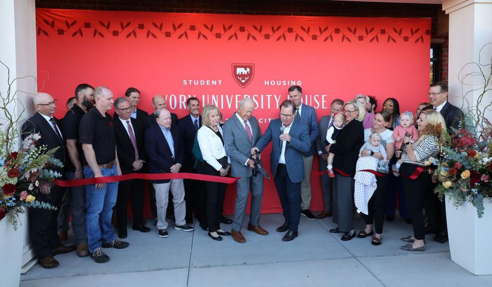 Roger Boyer, center left, and Clark Ivory cut the ribbon as the University of Utah, Ivory Family and The Church of Jesus Christ of Latter-day Saints celebrate the completion of the first of four student housing buildings at Ivory University House in Salt Lake City on Wednesday.