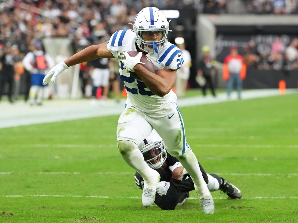 Indianapolis Colts running back Jonathan Taylor (28) evades the tackle of Las Vegas Raiders cornerback Rock Ya-Sin (26) last season.