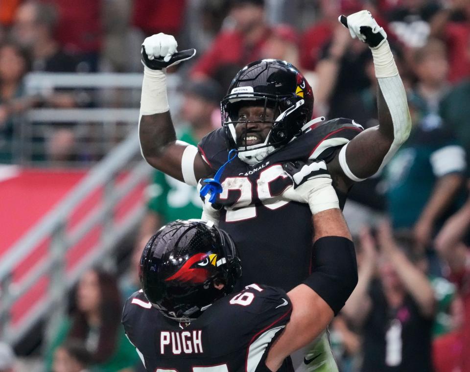 Oct 9, 2022; Glendale, Arizona, U.S.;  Arizona Cardinals running back Eno Benjamin (26) celebrates his touchdown run with guard Justin Pugh (67) during the fourth quarter against the Philadelphia Eagles at State Farm Stadium.