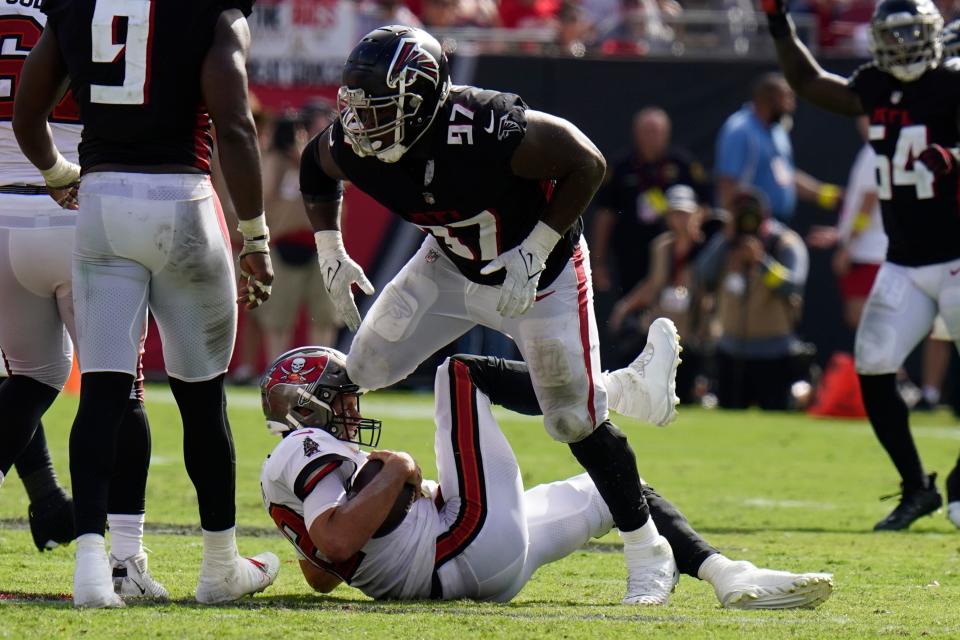 Atlanta Falcons defensive end Grady Jarrett (97) takes down Tampa Bay Buccaneers quarterback Tom Brady.