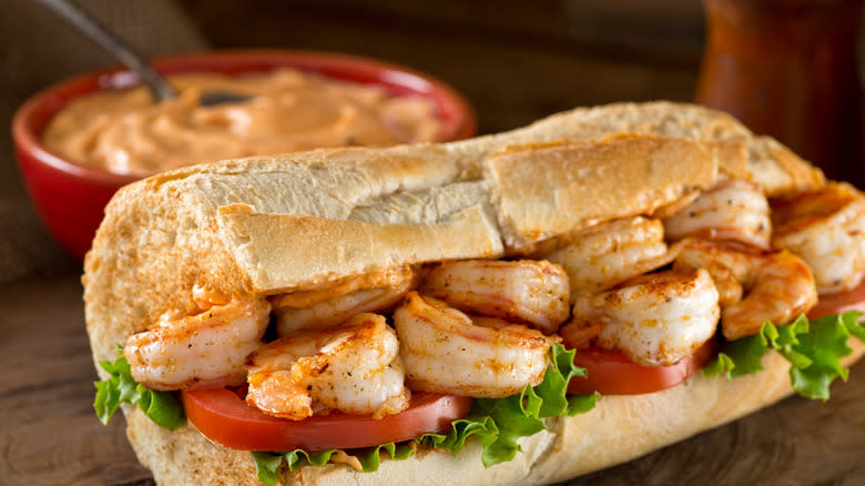 Shrimp po'boy sandwich with remoulade sauce on the side