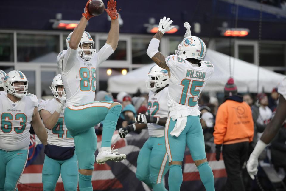 Miami Dolphins tight end Mike Gesicki, left, celebrates his winning touchdown catch with Albert Wilson, right, in the second half of an NFL football game against the New England Patriots, Sunday, Dec. 29, 2019, in Foxborough, Mass. (AP Photo/Elise Amendola)