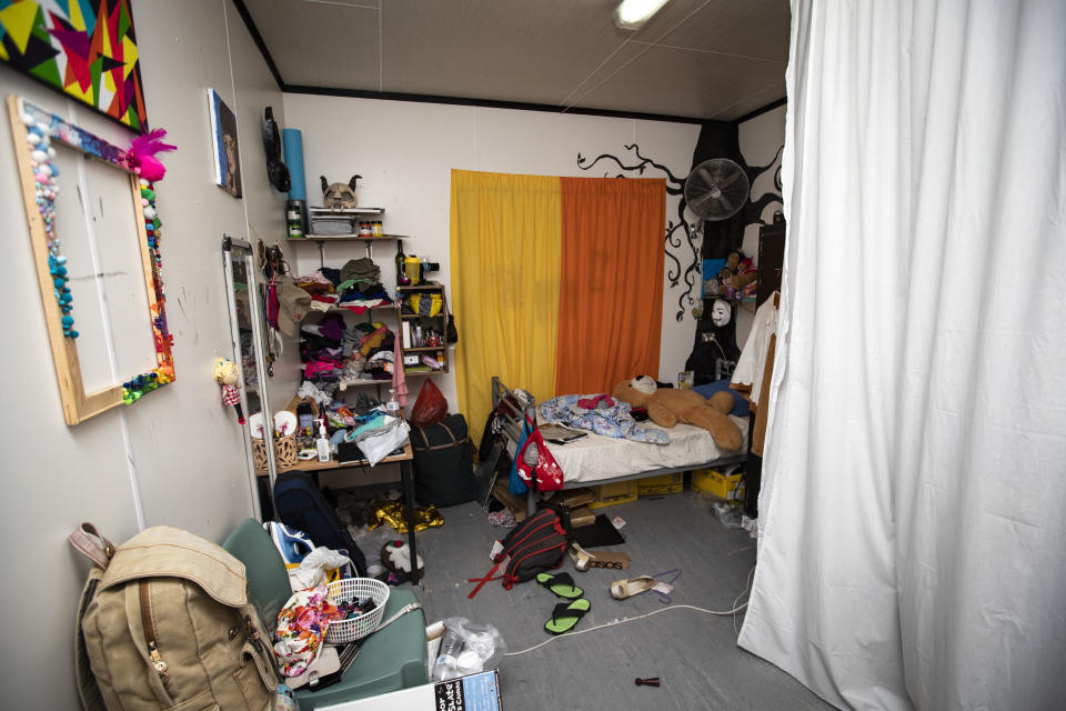 This Sept. 4, 2018, photo shows the bedroom of a teenage refugee in the Nibok refugee settlement on Nauru. She spends all her time here, and has installed a sheet to provide some privacy in a tiny space from her sister. About 120 refugee children and teenagers are living on Nauru. (Jason Oxenham/Pool Photo via AP)