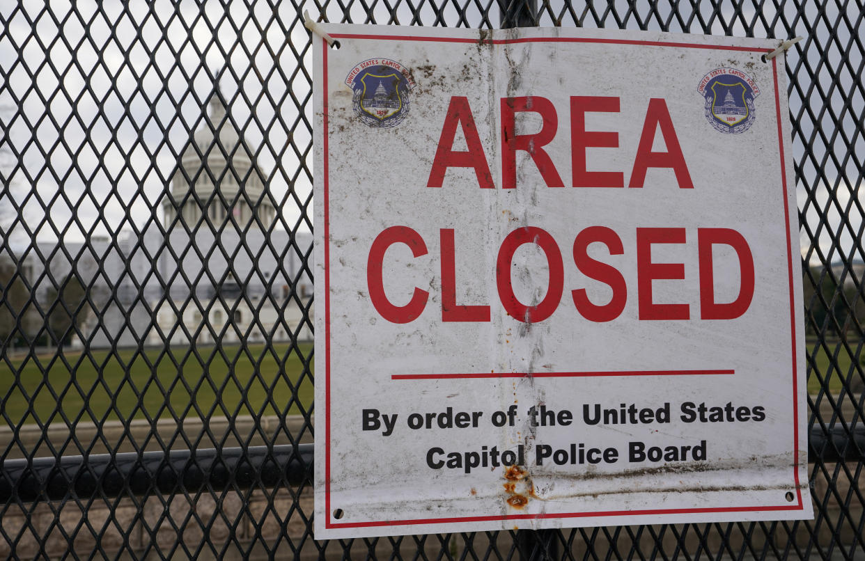 Metal security fencing and a sign stating 