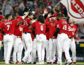 Cincinnati Reds' Nick Castellanos (2) celebrates with his teammates after hitting a home run against Washington Nationals pitcher Patrick Murphy to win the game during the ninth inning of a baseball game in Cincinnati Saturday, Sept. 25, 2021. The Reds won 7-6. (AP Photo/Paul Vernon)