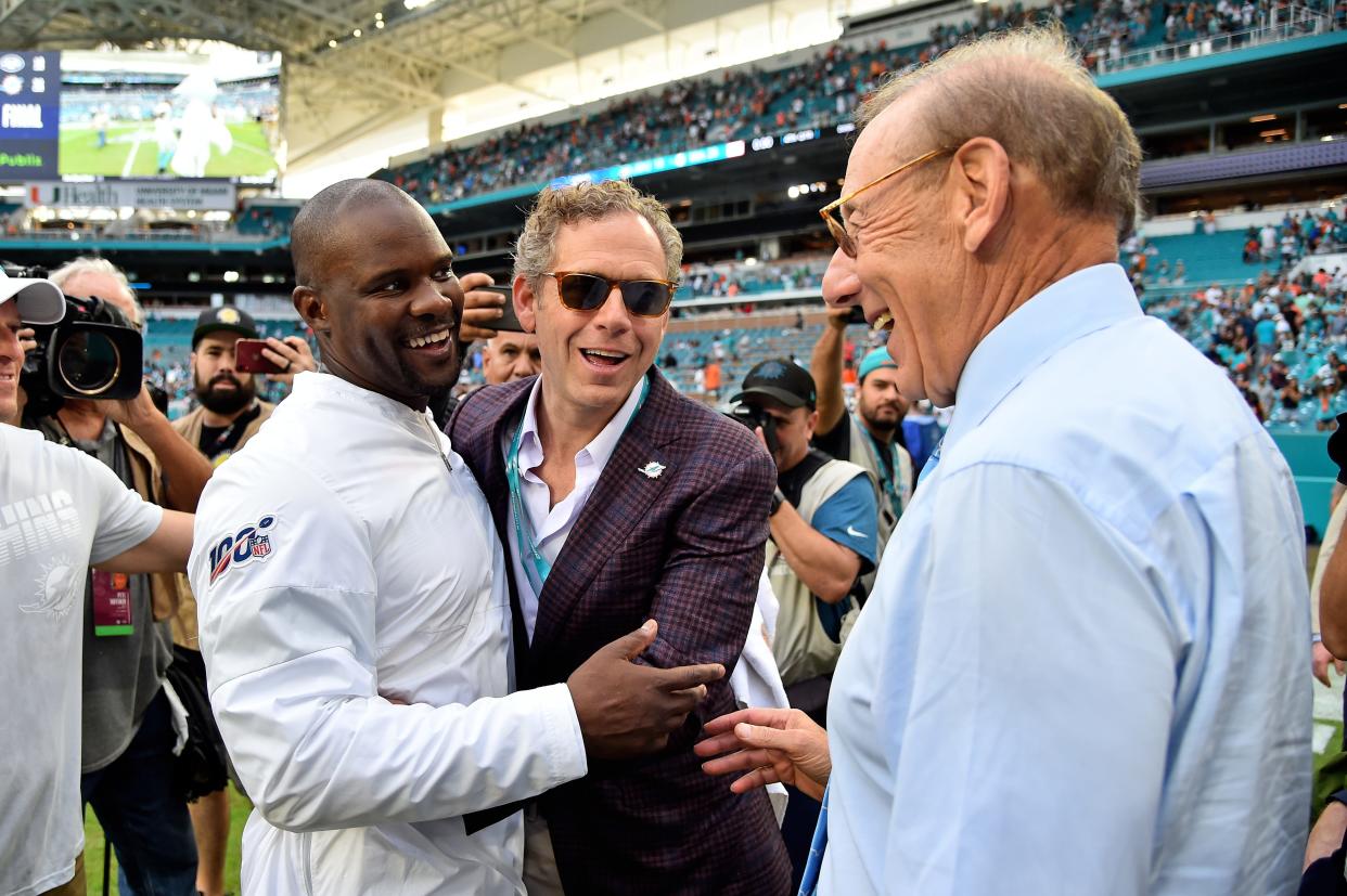 Nov 3, 2019; Miami Gardens, FL, USA; Miami Dolphins head coach Brian Flores (L) celebrates team vice chairman/partner Bruce Beal (C) and team owner Stephen Ross (R) after defeating the New York Jets at Hard Rock Stadium.