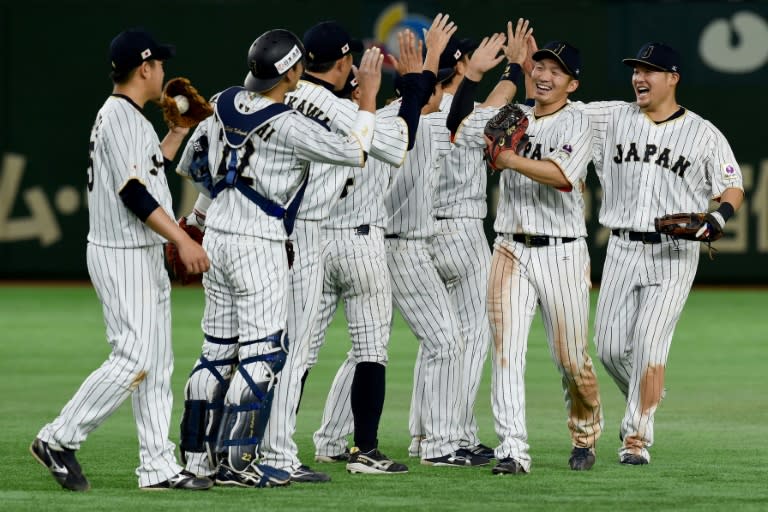 Japan's players celebrate their victory over Isreal after the top of the ninth inning during the World Baseball Classic Pool E second round match in Tokyo on March 15, 2017