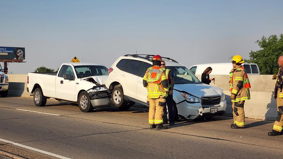 Emergency first responders look over a wreck Wednesday morning on Interstate 27 near the junction of Interstate 40.