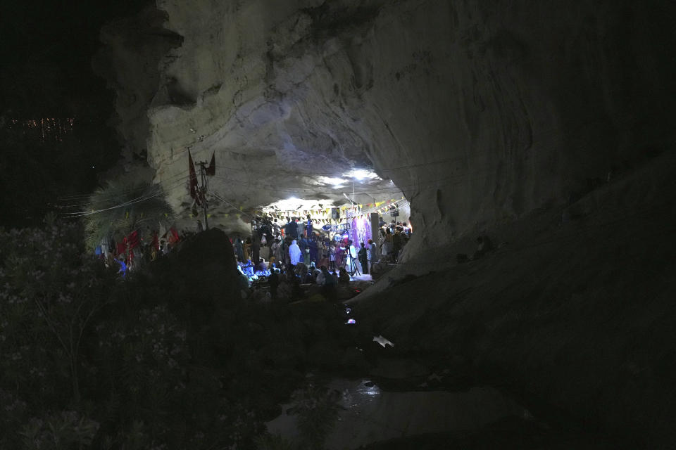 Hindu devotees attend an annual festival in an ancient cave temple of Hinglaj Mata in Hinglaj in Lasbela district in Pakistan's southwestern Baluchistan province, Friday, April 26, 2024. More than 100,000 Hindus are expected to climb mud volcanoes and steep rocks in southwestern Pakistan as part of a three-day pilgrimage to one of the faith's holiest sites. (AP Photo/Junaid Ahmed)