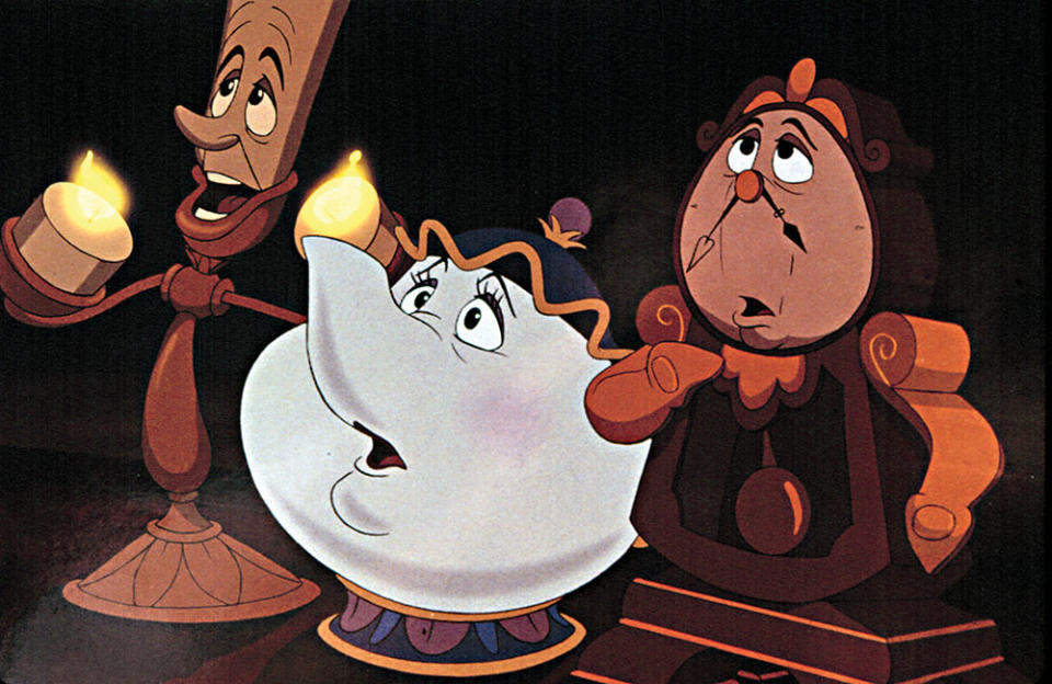 The characters Lumiere, Mrs. Potts and Cogsworth, household objects come to life, in a scene from Beauty and the Beast. - Credit: Buena Vista Pictures/Everett Collection.