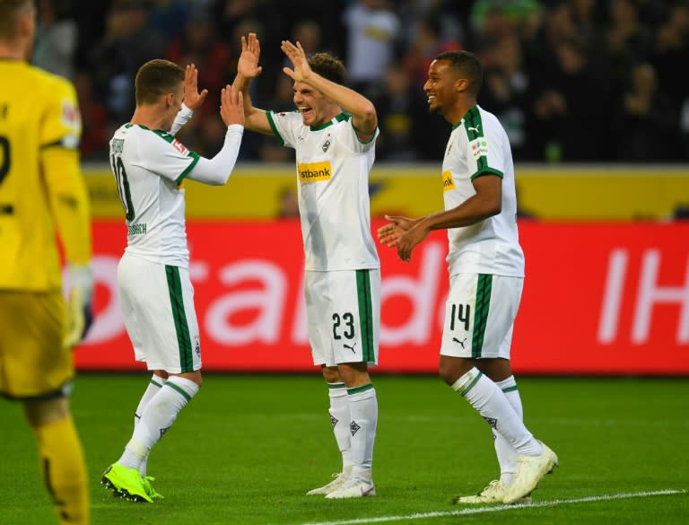 Borussia Moenchengladbach midfielder Jonas Hofmann (C) celebrates scoring his hat-trick in Sunday's 4-0 thrashing of Mainz, which left his team second in the Bundesliga table