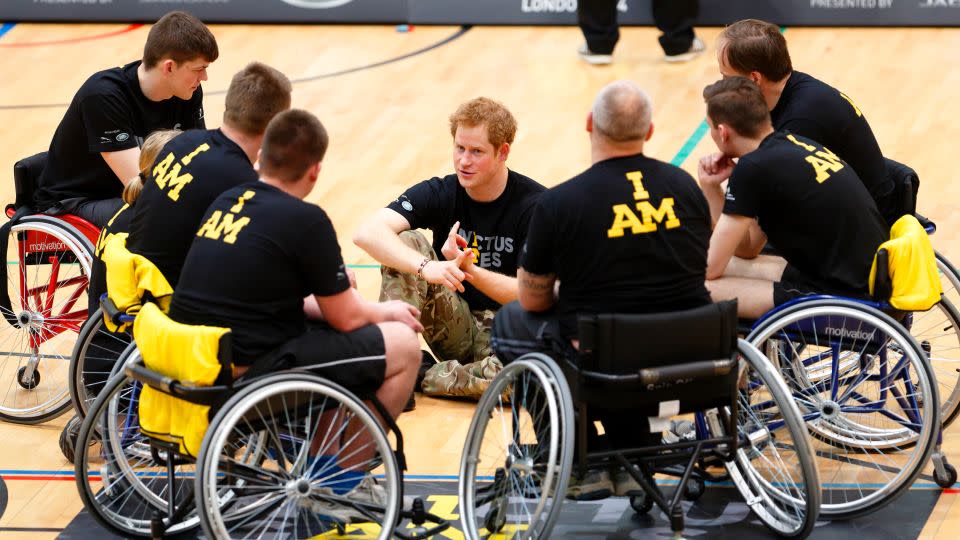 Prince Harry talks with wheelchair basketball players during the launch of the Invictus Games at the Copper Box Arena in London's Queen Elizabeth Olympic Park in March 2014. - Max Mumby/Indigo/Getty Images