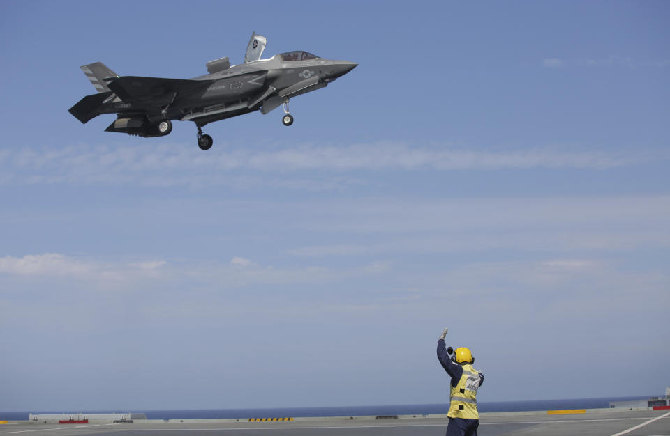 Military personnel guide an American F-35 during the NATO Steadfast Defender 2021 exercises on board the aircraft carrier HMS Queen Elizabeth off the coast of Portugal, Thursday, May 27, 2021. NATO has helped provide security in Afghanistan for almost two decades but the government and armed forces in the conflict-torn country are strong enough to stand on their own feet without international troops to back them, the head of the military organization said Thursday. (AP Photo/Ana Brigida)