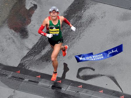 Apr 16, 2018; Boston, MA, USA; Yuki Kawauchi crosses the finish line of the 2018 Boston Marathon winning the men's division. Mandatory Credit: Brian Fluharty-USA TODAY Sports