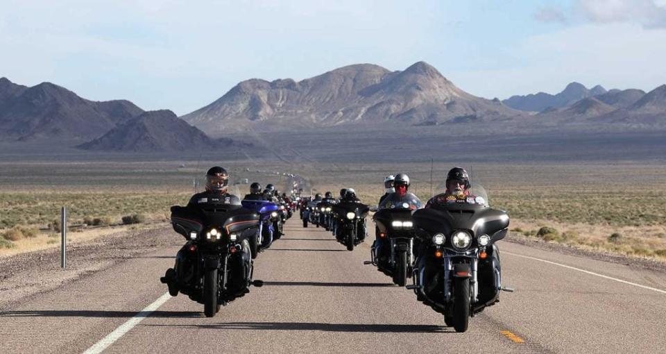 Riders on the Kyle Petty Charity Ride Across America, with scenic long-range mountains as a backdrop