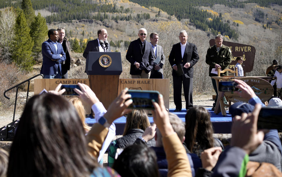 President Joe Biden, center, joins other speakers on stage before Biden designated the first national monument of his administration at Camp Hale, a World War II era training site, Wednesday, Oct. 12, 2022, near Leadville, Colo. (AP Photo/David Zalubowski)