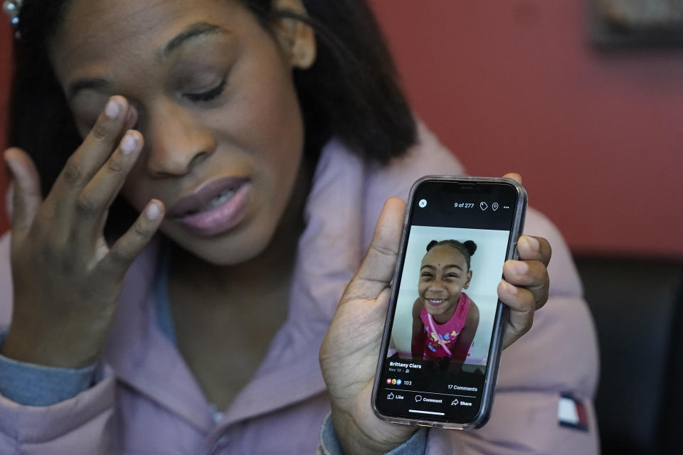 FILE - Brittany Tichenor-Cox, holds a photo of her daughter, Isabella "Izzy" Tichenor, during an interview, Nov. 29, 2021, in Draper, Utah. Tichenor-Cox said her 10-year-old daughter died by suicide after she was harassed for being Black and autistic at school. A Black woman hired by a northern Utah school district to investigate racial harassment complaints a year after Tichenor died by suicide says that she, too, experienced discrimination from district officials. Joscelin Thomas, a former coordinator in the Davis School District's equal opportunity office, alleges in a federal lawsuit that district administrators treated her “as if she were stupid," accused her of having a substandard work ethic and denied her training and mentorship opportunities that were offered to her white colleagues. (AP Photo/Rick Bowmer)