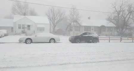 Snow-covered cars are seen during the blizzard in Greeley, Colorado, U.S. March 13, 2019 in this picture obtained from social media. Mandatory credit TWITTER @PHOTOWILLG/via REUTERS