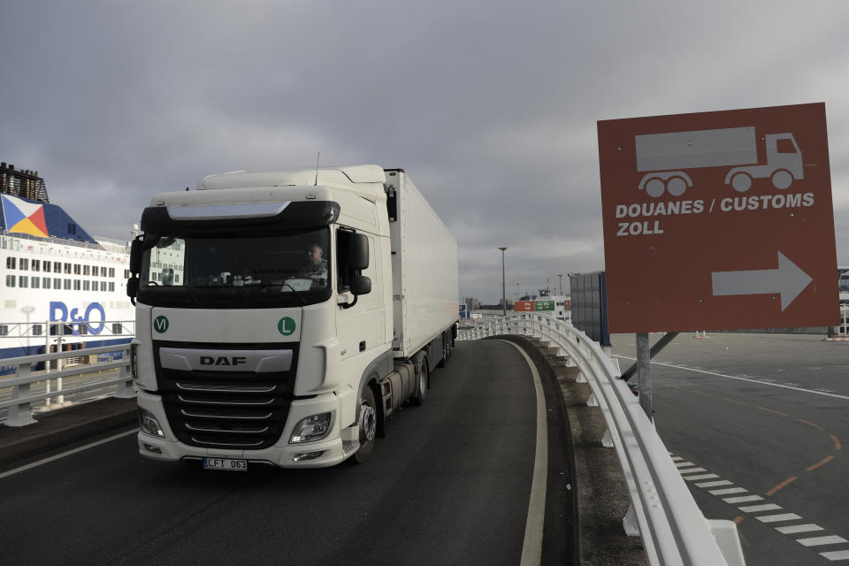 A lorry arrives to board the first ferry heading to Britain after Brexit, Friday Jan.1, 2021 in Calais, northern France. Britain left the European bloc's vast single market for people, goods and services at 11 p.m. London time, midnight in Brussels, completing the biggest single economic change the country has experienced since World War II. (AP Photo/Lewis Joly)