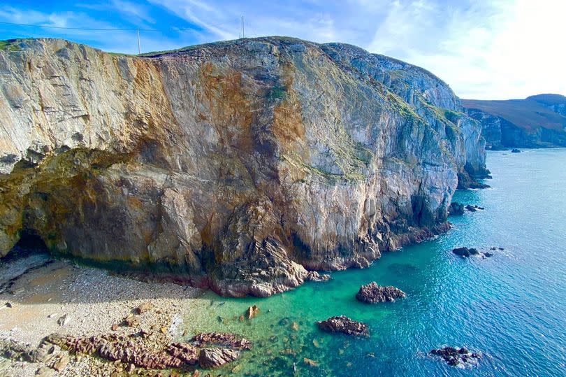 North Stack's vast Parliament House Cave, so called because its garrulous seabirds seem to squabble like politicians. Viewed from above on a summer's day, visitors remark on the scene's Mediterranean feel