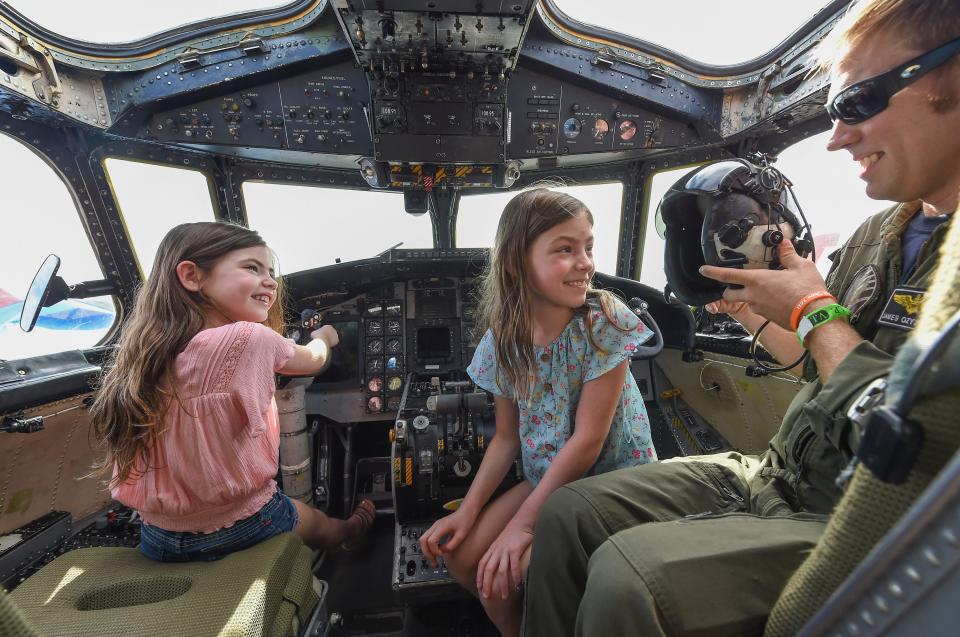 Karly Krouse (left) 5, and her sister Layla Krause, 8, inside the cockpit of an aircraft.