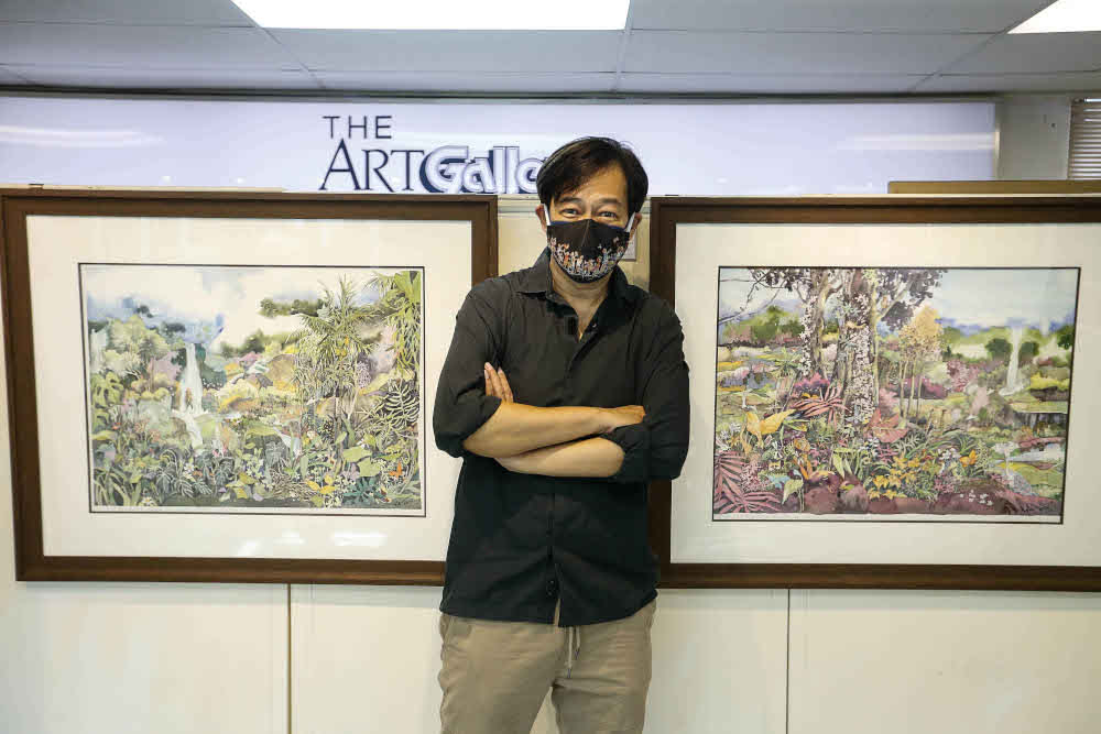 Alex Leong poses for a photo with his paintings during an interview regarding his work being previewed here at The Art Gallery, Pulau Tikus October 15, 2021. — Pictures by Sayuti Zainudin