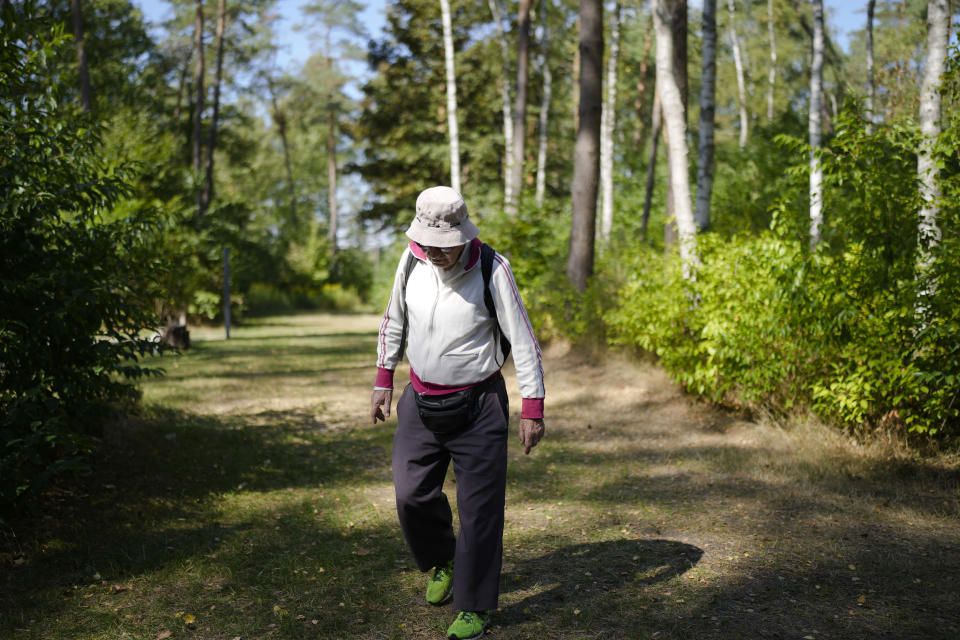 Israeli Olympic race walker Shaul Ladany walks through the former Nazi concentration camp Bergen-Belsen in Bergen, Germany, Saturday, Sept. 3, 2022. Shaul Ladany survived a Nazi concentration camp and narrowly escaped the massacre of the Israeli athletes at the 1972 Olympic Games in Munich. Both attempts to murder him happened on German soil in the last century. Many decades later, the 86-year-year old Jew has returned to visit the two places where he narrowly escaped death. (AP Photo/Markus Schreiber)